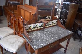 A Victorian mahogany framed wash stand having mirror and tiled back, with marble top , two frieze