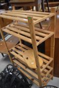 A natural pine slatted utility shelf and wooden chopping or serving board