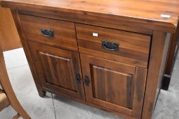 A modern hardwood sideboard having two drawers and double cupboard, with dark metal handles,