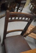 A set of four Victorian mahogany dining chairs having bobbin turned rail backs and brown leather