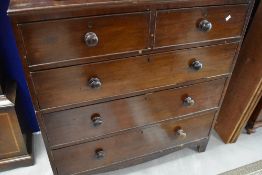 A Victorian mahogany chest of two over three drawers having turned handles and bracket feet,