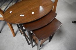 An early 20th Century mahogany nest of three table, the top one being oval, approx. 58 x 40cm