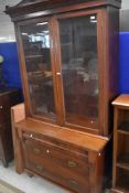 A Victorian mahogany bookcase, having cupboard base with 'secret' drawer over two long drawers,