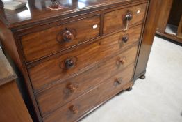 A Victorian mahogany chest of two over three drawers having interesting turned handles and bracket