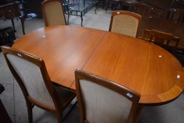 A vintage oval dining table, G plan or similar and four similar dining chair, labelled for William