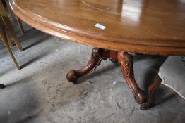 A Victorian dining or breakfast table having oval top on turned column and quadruple splay legs ,
