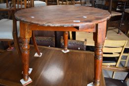 A 19th Century pine cricket table having circular top and triple splay turned legs, diameter approx.