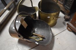 A 19th Century copper coal helmet and two later brass coal helmets