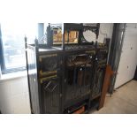 A late Victorian ebonised display cabinet in the Aesthetic style, having elaborate brass hinges,