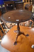 A 19th Century mahogany pedestal table having circular lipped top on turned column and triple