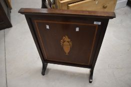 An Edwardian fire screen having inlaid vase decoration