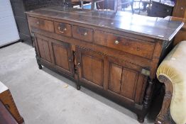 A late 18th Century oak sideboard or dresser base having two narrow centre drawers ,flanked by a