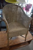 A vintage Lloyd Loom tub chair, in gold finish