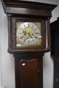 An 18th Century oak long cased clock, having square hood containing eight day movement with brass