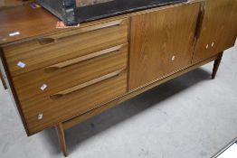 A vintage (mid Century) teak sideboard in the Scandinavian style, comprising three drawers , with