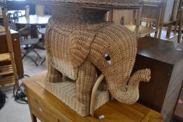 A vintage wicker side occasional table modelled as an elephant, width approx. 61cm