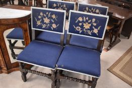 A set of four late 19th or early 20th Century dining chairs having turned frames with upholstered