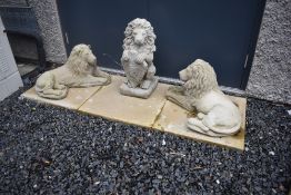 Three ornamental concrete lions , one standing rampant with shield (Welcome), two lying passant,
