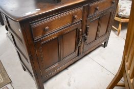 A dark stained Ercol sideboard, width approx 120cm