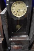 An early 20th Century oak cased time recorder clock, dial named for Gledhill-Brook, sold with