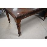 A late Victorian mahogany extending dining table, of rectangular form with moulded edge detail and