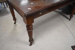 A late Victorian mahogany extending dining table, of rectangular form with moulded edge detail and