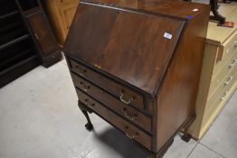 A mid 20th century mahogany bureau having typical drop flap section, with stationery fitted