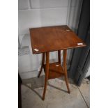 An early 20th Century stained frame plant stand having square top and undertier, on splay legs,