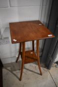 An early 20th Century stained frame plant stand having square top and undertier, on splay legs,