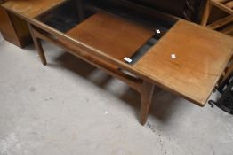 A vintage teak and glass top coffee table , probably G plan, approx. 137 x 51cm