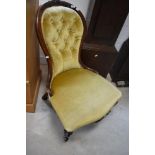 A Victorian mahogany framed spoon back nursing chair, having mustard dralon button back upholstery