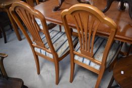 A nice quality modern yew effect extending dining table and set of six (four plus two) similar