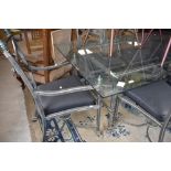 An Italian designer style glass top table with burnished metal frame and set of six (four plus