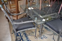 An Italian designer style glass top table with burnished metal frame and set of six (four plus