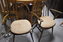 A pair of Vintage Ercol carver chairs in mid/dark stain