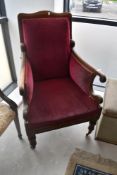 A Victorian mahogany scroll armchair , having later burgundy upholstery