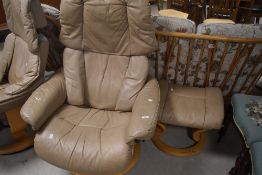 A Stressless recliner armchair and footstool in cream leather on light beech frame