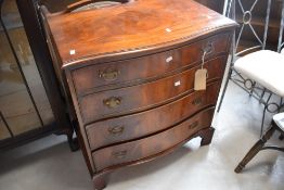 A reproduction mahogany serpentine front chest of four long drawers, on bracket feet , dimensions