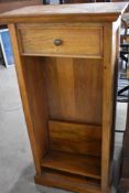 A modern hardwood narrow bookshelf , with drawer to top, dimensions approx. height 123 width 60