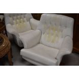 A pair of vintage cream vinyl swivel lounge chairs, having button backs, probably G plan 6250 (