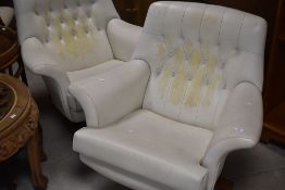 A pair of vintage cream vinyl swivel lounge chairs, having button backs, probably G plan 6250 (