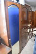 An Edwardian mahogany bedroom suite comprising three piece wardrobe (as found with reverse