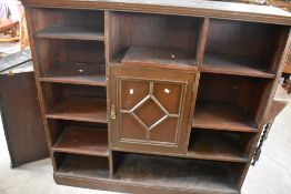 A late 19th or early 20th Century stained frame bookshelf having central cupboard, dimensions