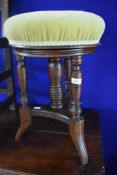 A Victorian mahogany piano stool , having revolving top on turned frame