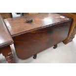 A 19th Century mahogany drop leaf dining table, having turned column and quadruple carved shaped