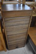 A vintage sapele tambour fronted cabinet, having internal drawers and shelves, dimensions approx.