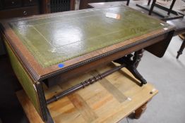 A reproduction Regency sofa style coffee table having drop flap ends and turned support on claw feet