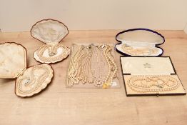 A collection of faux pearl necklaces, four in cases