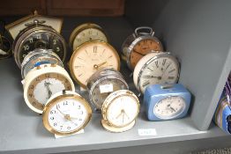 A large quantity of early to mid 20th-century mechanical alarm and mantel clocks, to feature