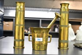 A 20th-century brass pestle and mortar; sold with two brass Trench Art 40mm artillery shell cases,